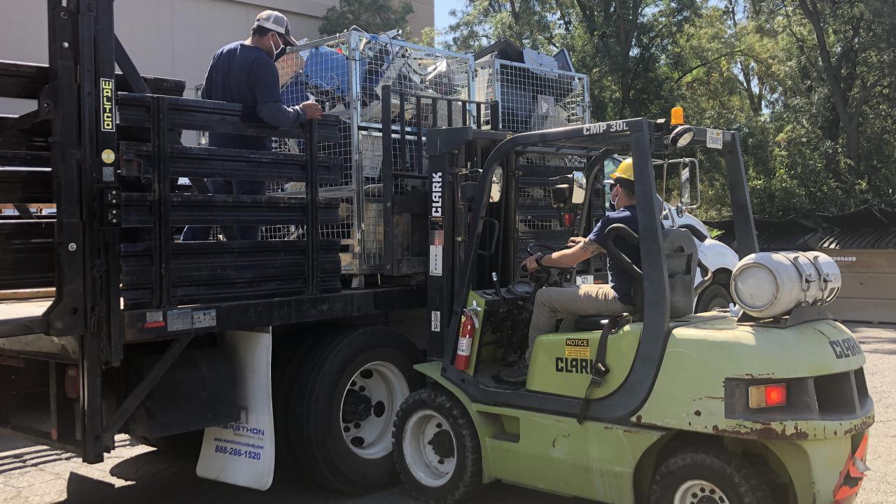 Special Services employees hauling boxes from Tupper Hall