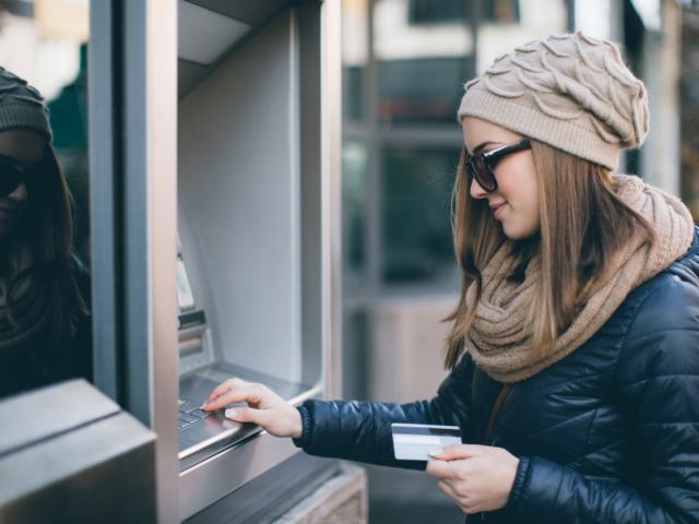 student using card at atm